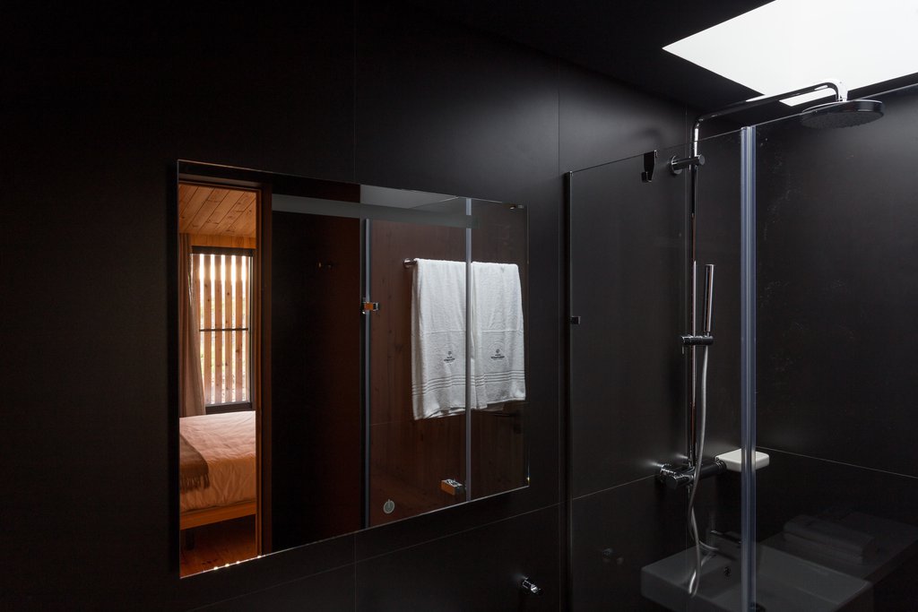 Studio accommodations/lodging at Quinta dos Peixes Falantes: elegant, modern, black tile bathroom with shower and fixtures