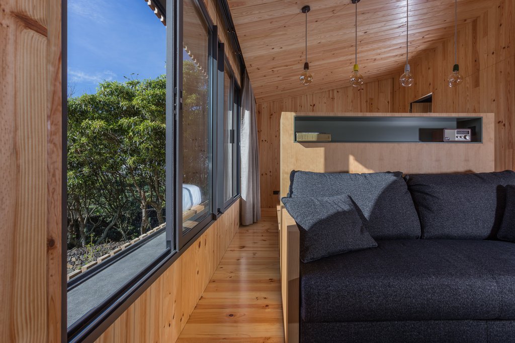 Studio accommodations Quinta dos Peixes Falantes: elegant bedroom finished in wood adjacent large picture window
